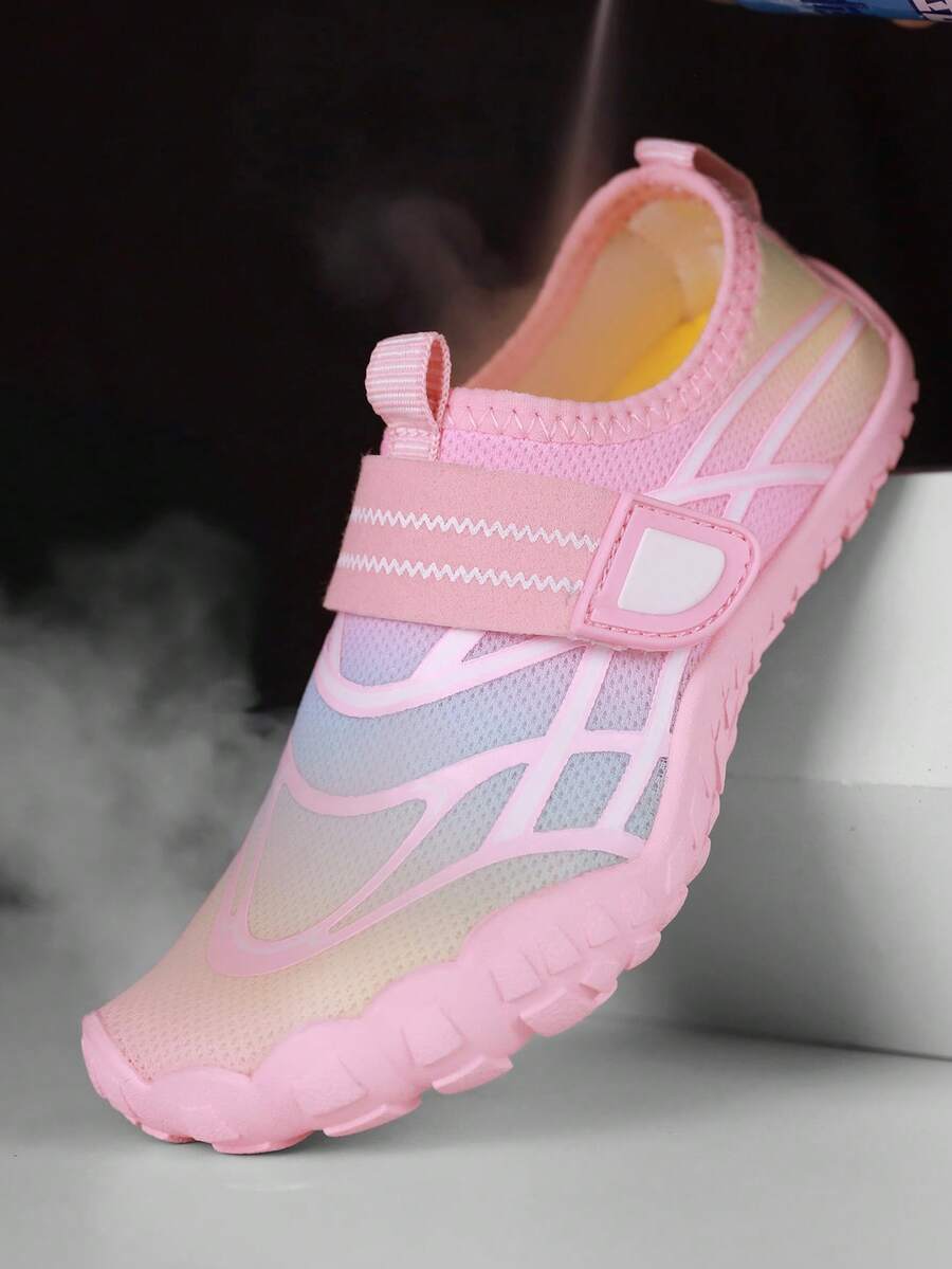 Black kids water shoes with graphic pattern, fabric upper, hook and loop closure, and non-slip rubber outsole for boys and girls.
