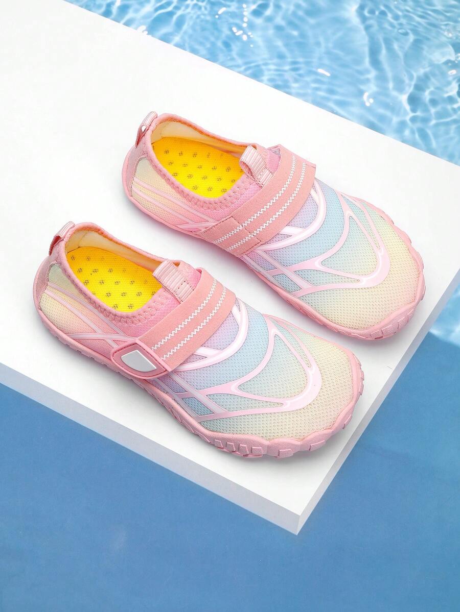 Black kids water shoes with graphic pattern, fabric upper, hook and loop closure, and non-slip rubber outsole for boys and girls.