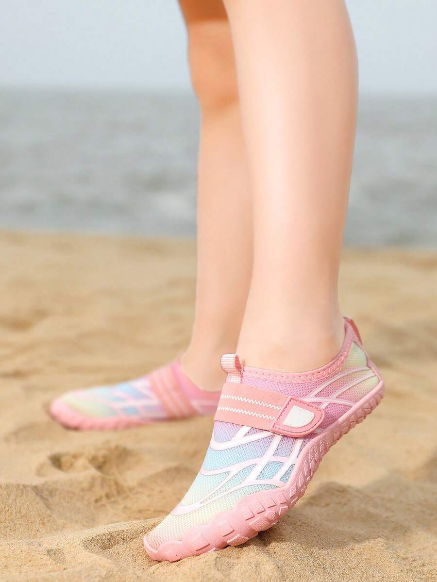 Black kids water shoes with graphic pattern, fabric upper, hook and loop closure, and non-slip rubber outsole for boys and girls.