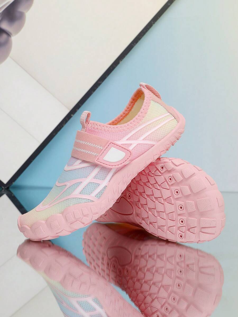Black kids water shoes with graphic pattern, fabric upper, hook and loop closure, and non-slip rubber outsole for boys and girls.