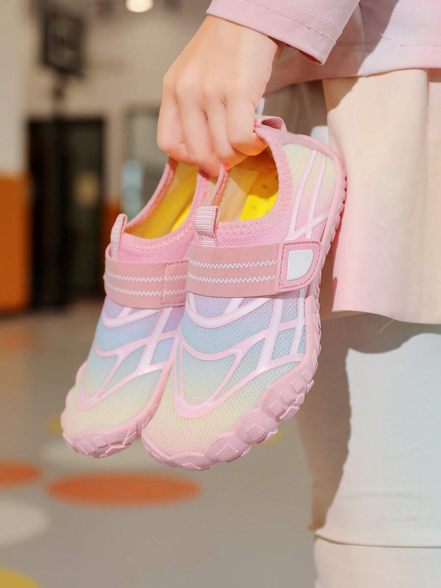 Black kids water shoes with graphic pattern, fabric upper, hook and loop closure, and non-slip rubber outsole for boys and girls.
