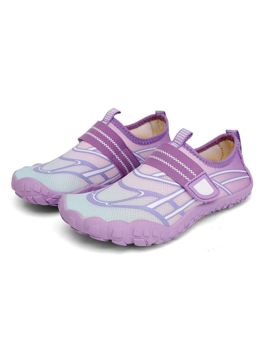 Black kids water shoes with graphic pattern, fabric upper, hook and loop closure, and non-slip rubber outsole for boys and girls.