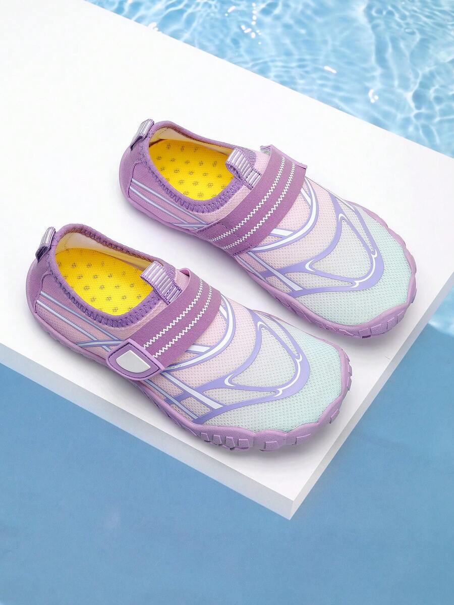Black kids water shoes with graphic pattern, fabric upper, hook and loop closure, and non-slip rubber outsole for boys and girls.