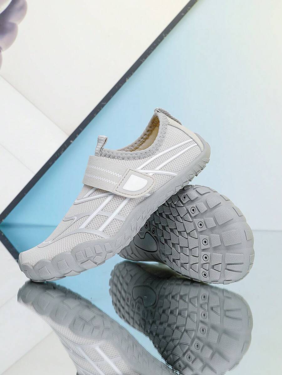 Black kids water shoes with graphic pattern, fabric upper, hook and loop closure, and non-slip rubber outsole for boys and girls.