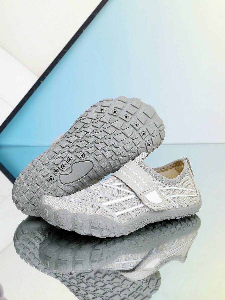 Black kids water shoes with graphic pattern, fabric upper, hook and loop closure, and non-slip rubber outsole for boys and girls.