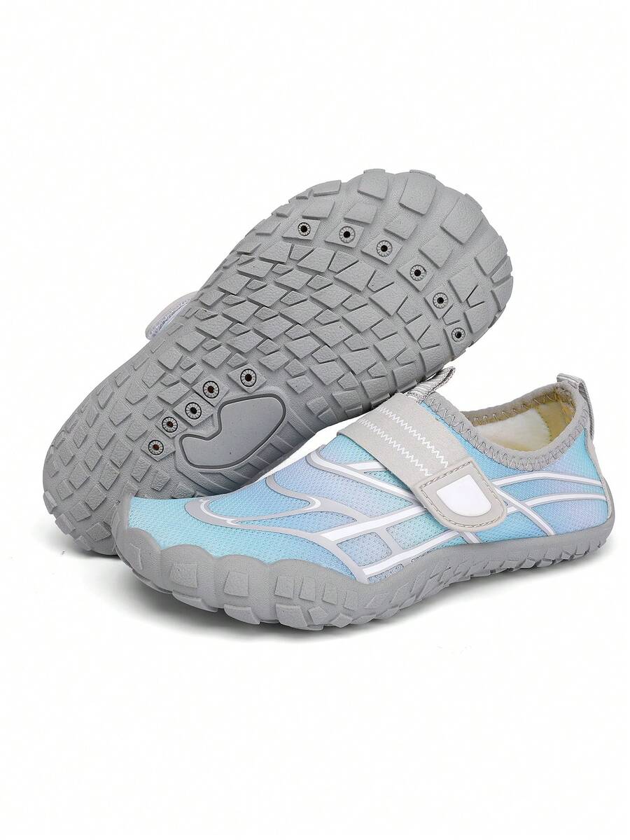 Black kids water shoes with graphic pattern, fabric upper, hook and loop closure, and non-slip rubber outsole for boys and girls.