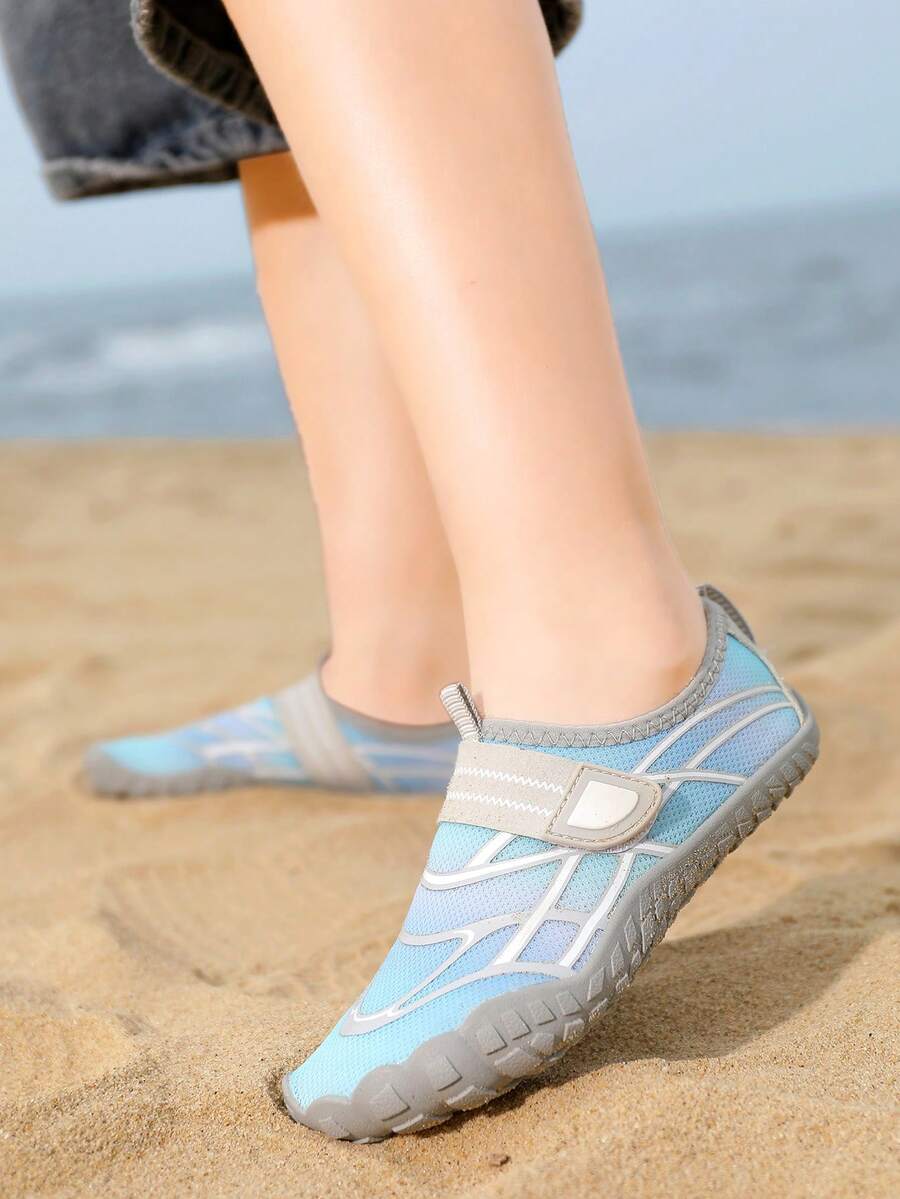 Black kids water shoes with graphic pattern, fabric upper, hook and loop closure, and non-slip rubber outsole for boys and girls.