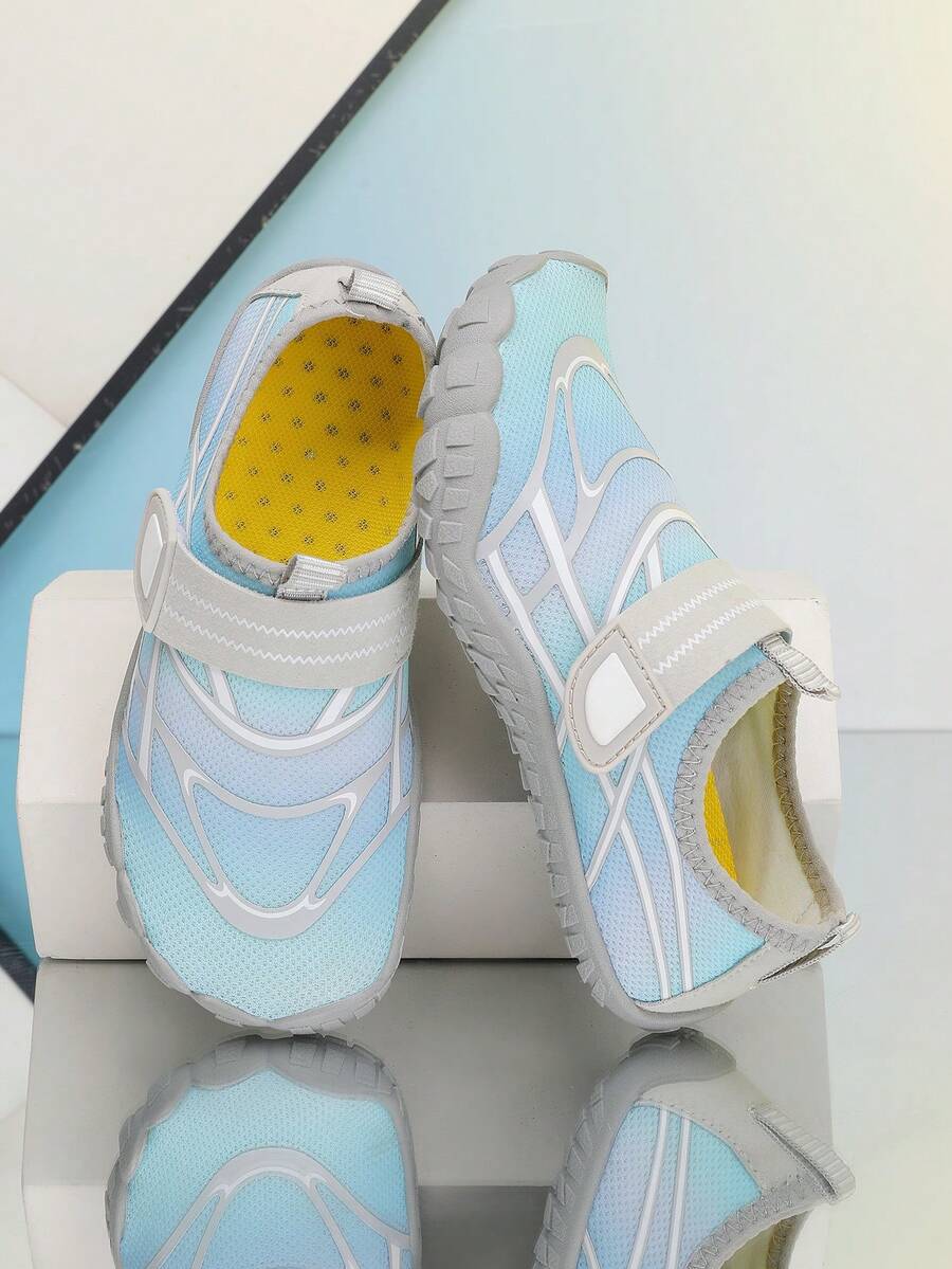 Black kids water shoes with graphic pattern, fabric upper, hook and loop closure, and non-slip rubber outsole for boys and girls.