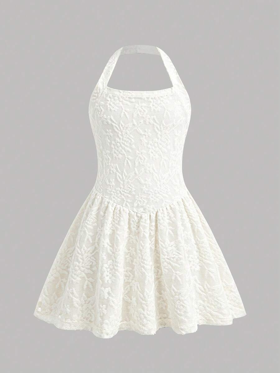 Black sleeveless halter polka dot mini dress for tween girls featuring a high waist and flared hem