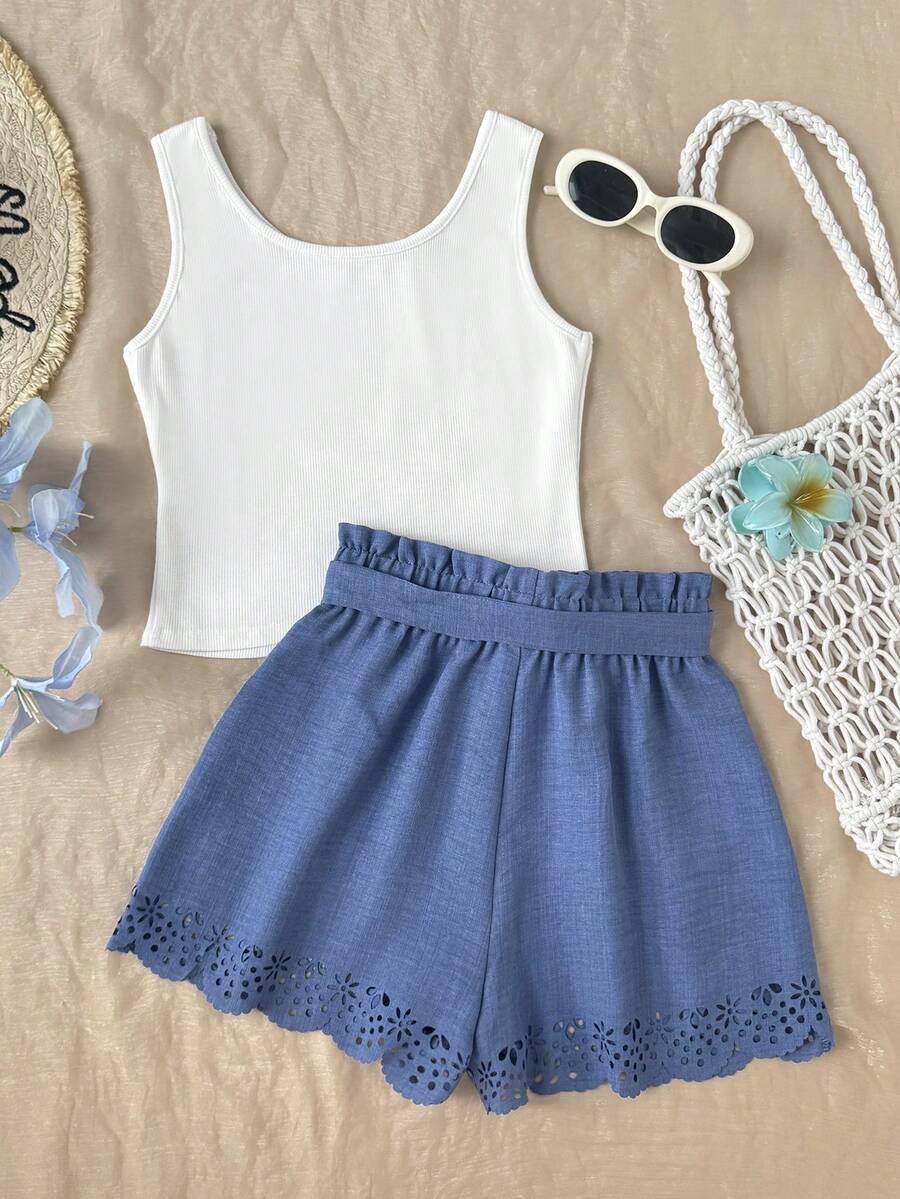 Tween girl wearing a casual 2-piece set featuring a black rib-knit scoop neck tank top and leopard print paperbag waist shorts with a matching belt.