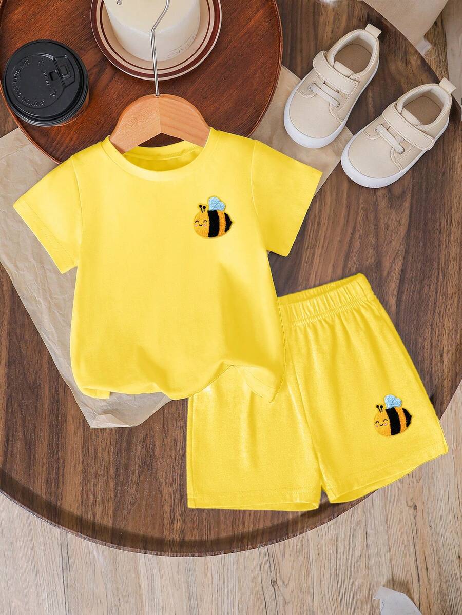 Tween girls two-piece green summer outfit featuring a fruit print short sleeve round neck t-shirt and matching track shorts with pockets.