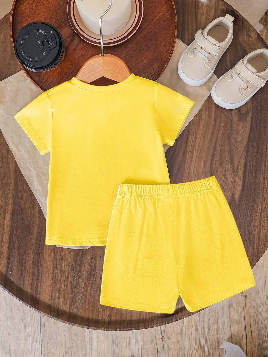 Tween girls two-piece green summer outfit featuring a fruit print short sleeve round neck t-shirt and matching track shorts with pockets.