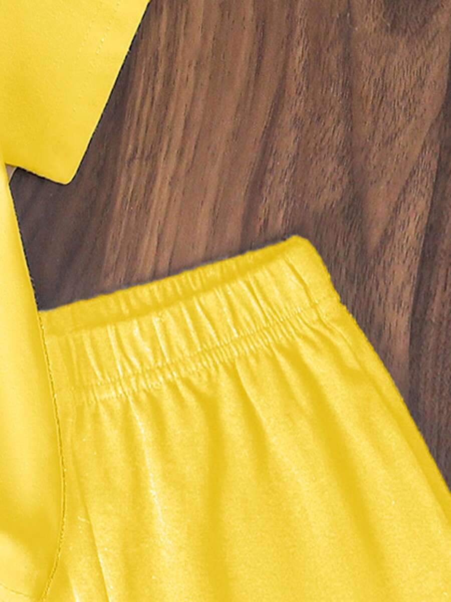 Tween girls two-piece green summer outfit featuring a fruit print short sleeve round neck t-shirt and matching track shorts with pockets.