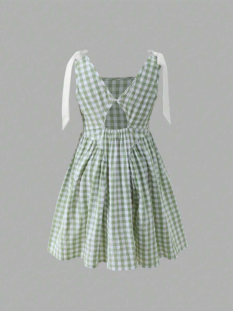 Black and white polka dot sleeveless A-line dress for tween girls featuring a scoop neck, high waist, and flared hem.