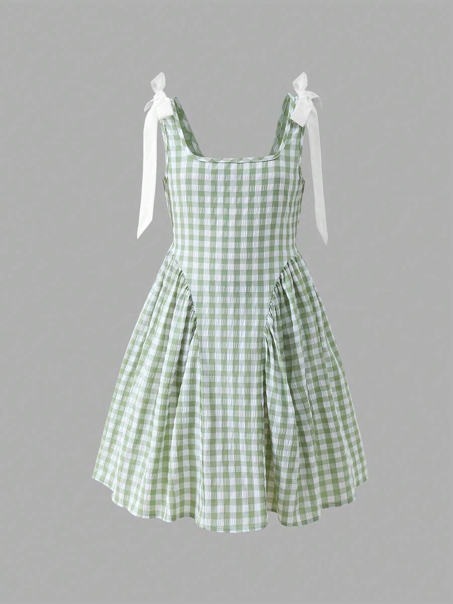 Black and white polka dot sleeveless A-line dress for tween girls featuring a scoop neck, high waist, and flared hem.