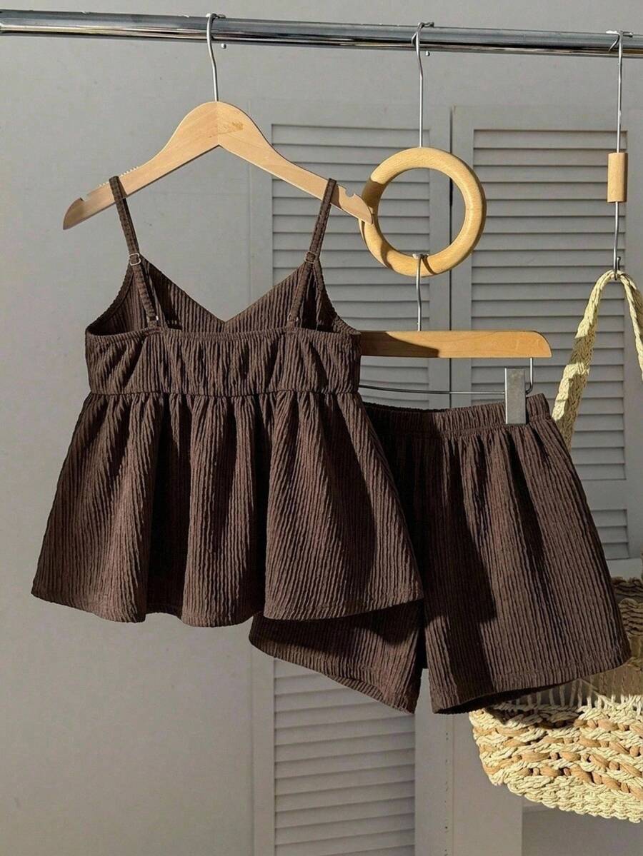 Tween girl 2-piece summer set with a black and white sleeveless striped spaghetti strap tank top with ruffle details and matching casual shorts.