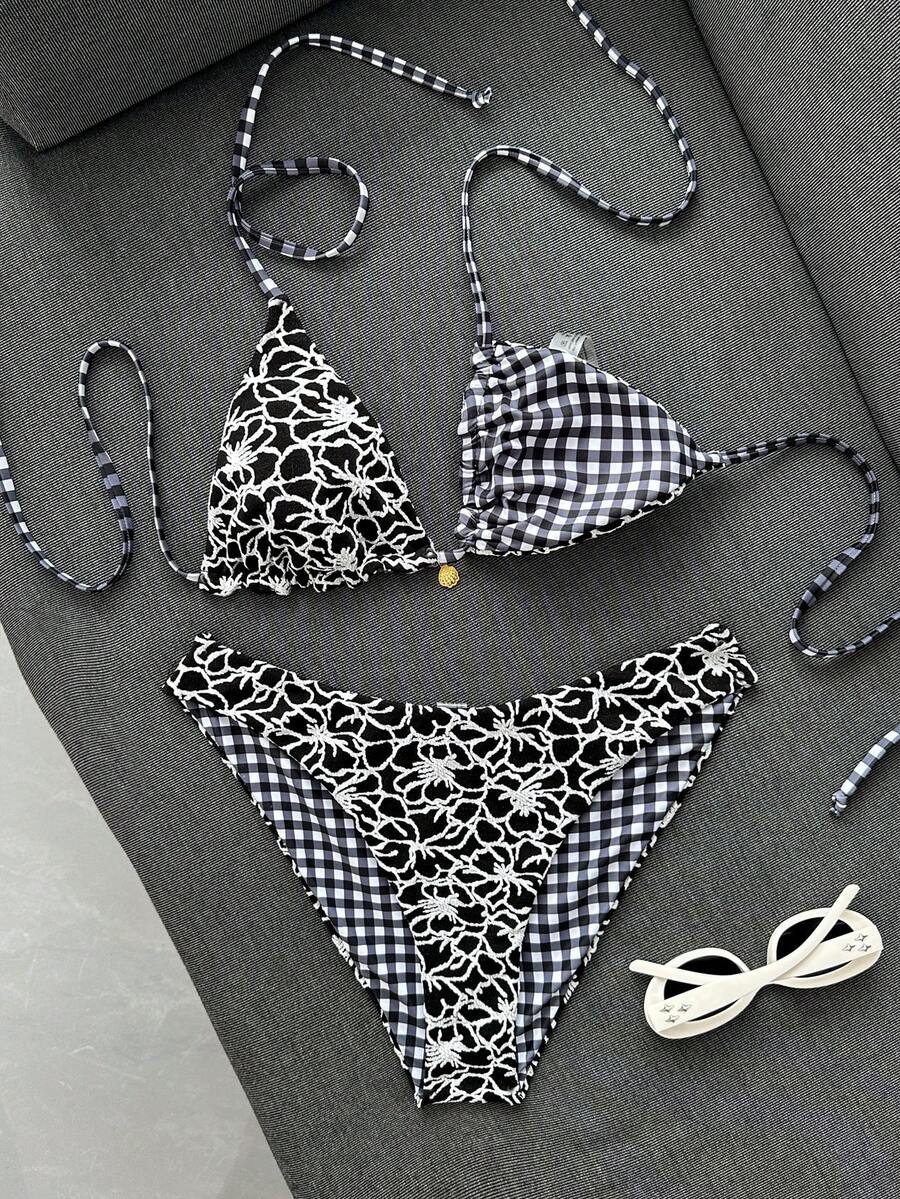 Women's black textured plaid 2-piece bikini set featuring a halter neckline, wireless triangle cups with removable padding, and mid-waist bottoms.