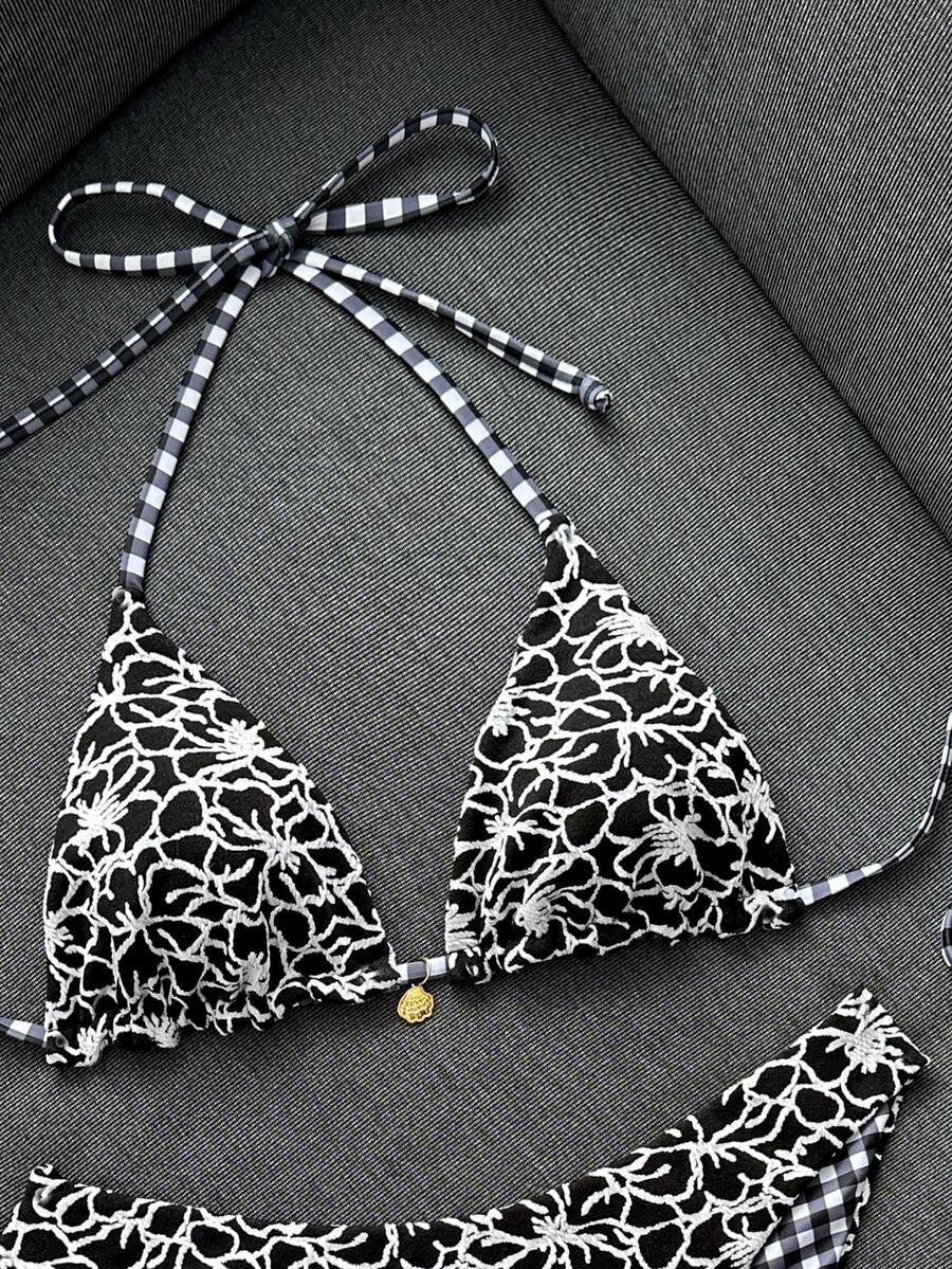 Women's black textured plaid 2-piece bikini set featuring a halter neckline, wireless triangle cups with removable padding, and mid-waist bottoms.