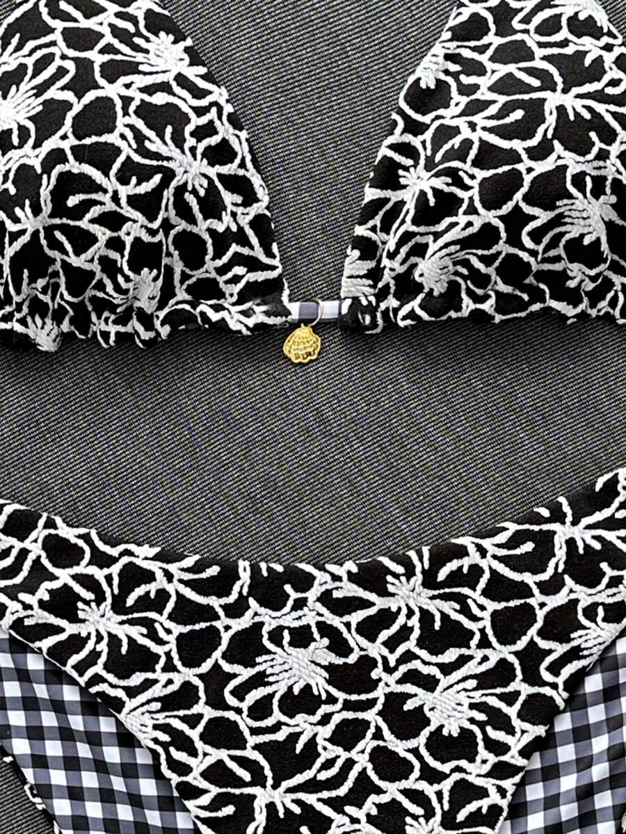Women's black textured plaid 2-piece bikini set featuring a halter neckline, wireless triangle cups with removable padding, and mid-waist bottoms.