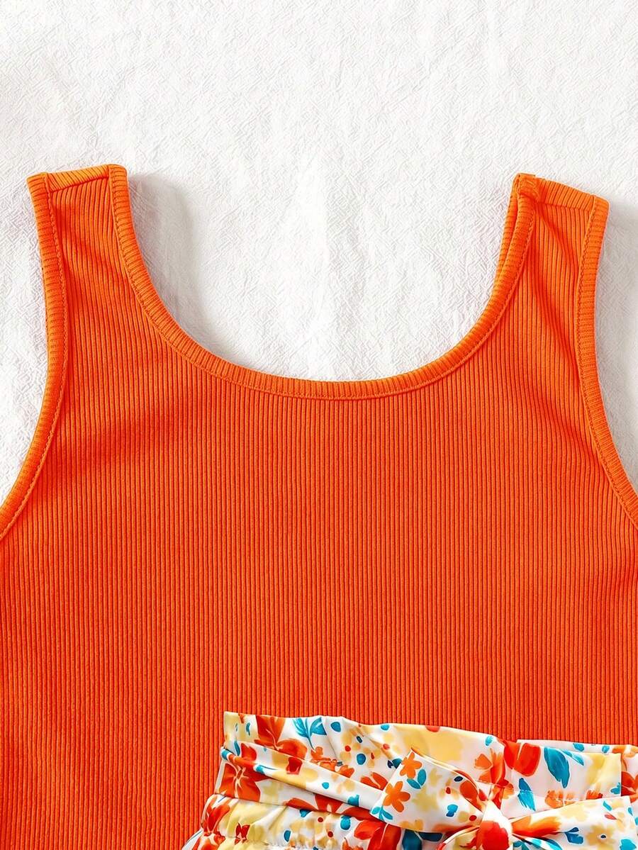 Tween girls 2-piece summer set featuring a turquoise blue ribbed tank top and tropical leaf pattern belted shorts.