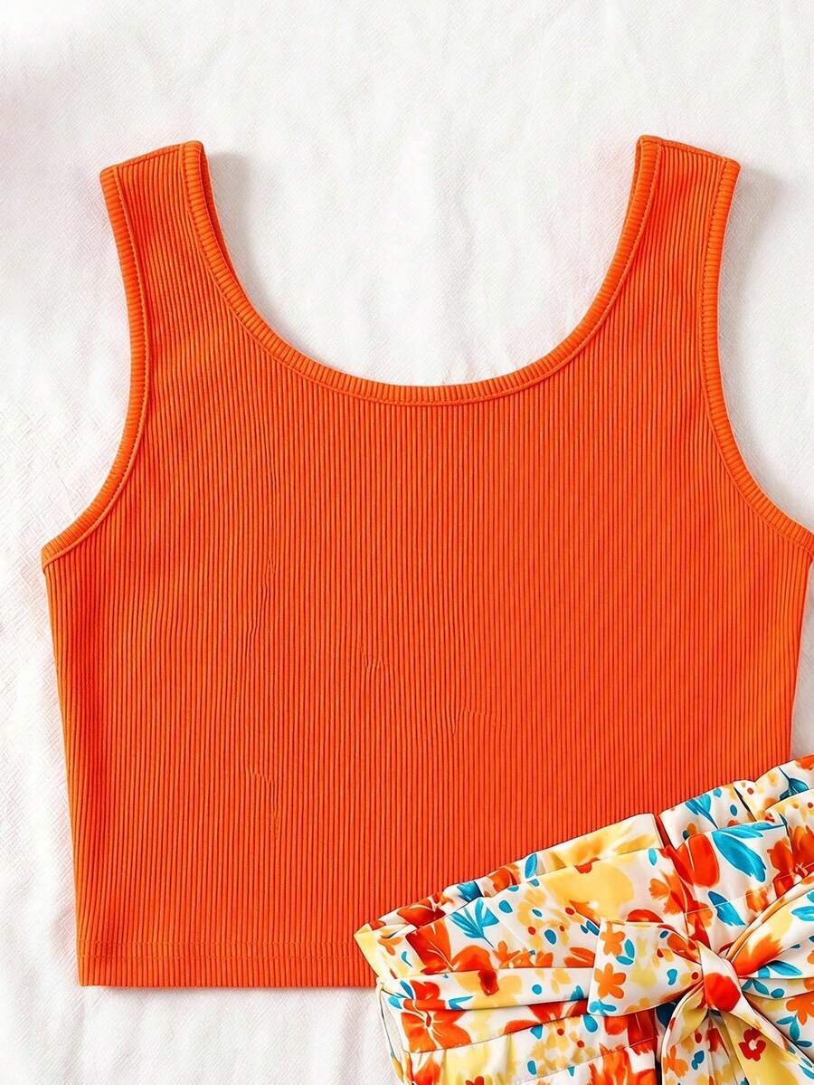Tween girls 2-piece summer set featuring a turquoise blue ribbed tank top and tropical leaf pattern belted shorts.