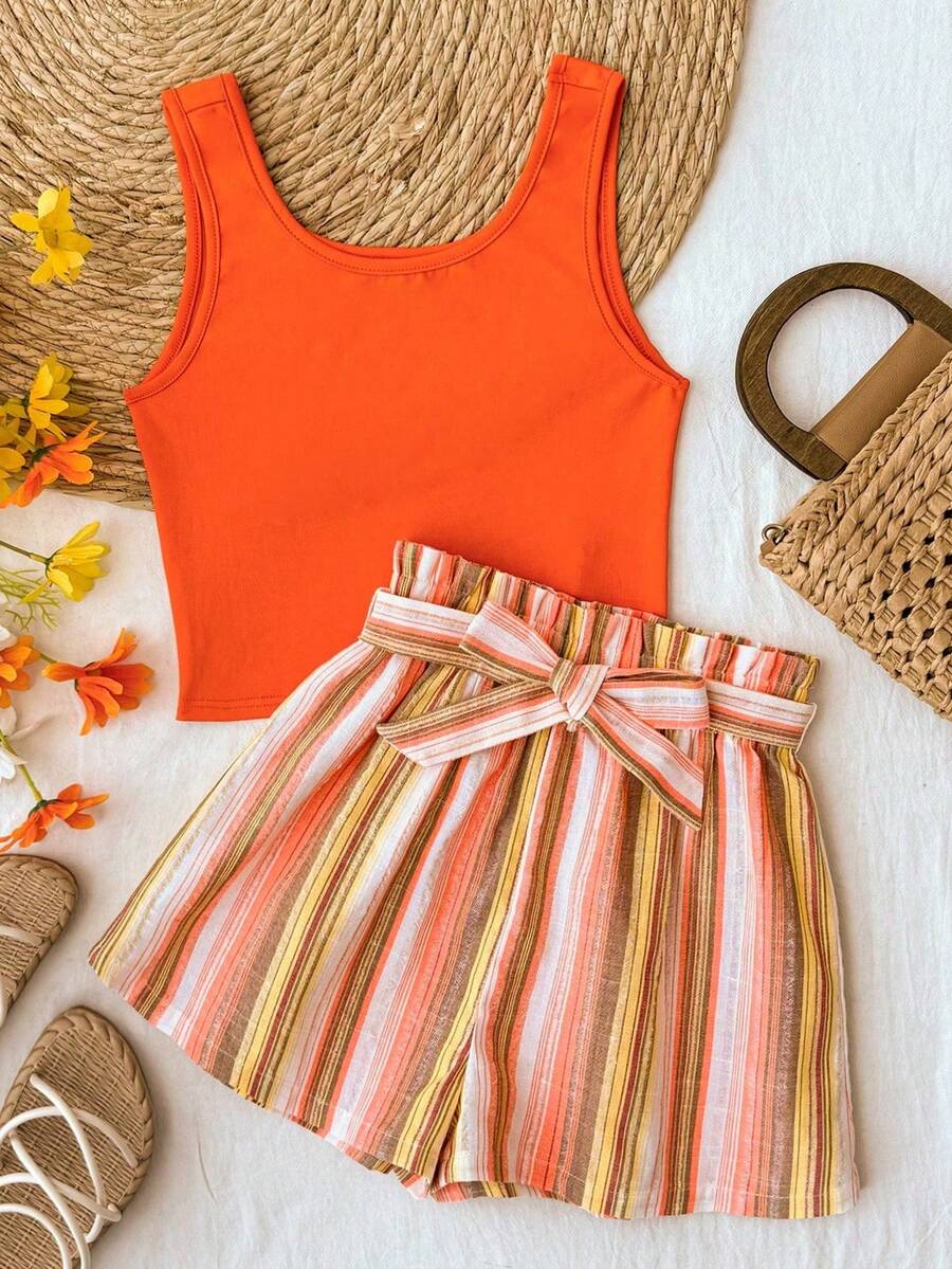 Tween girl summer two-piece outfit featuring a white scoop neck tank top and green ditsy floral print paperbag waist shorts with belt.