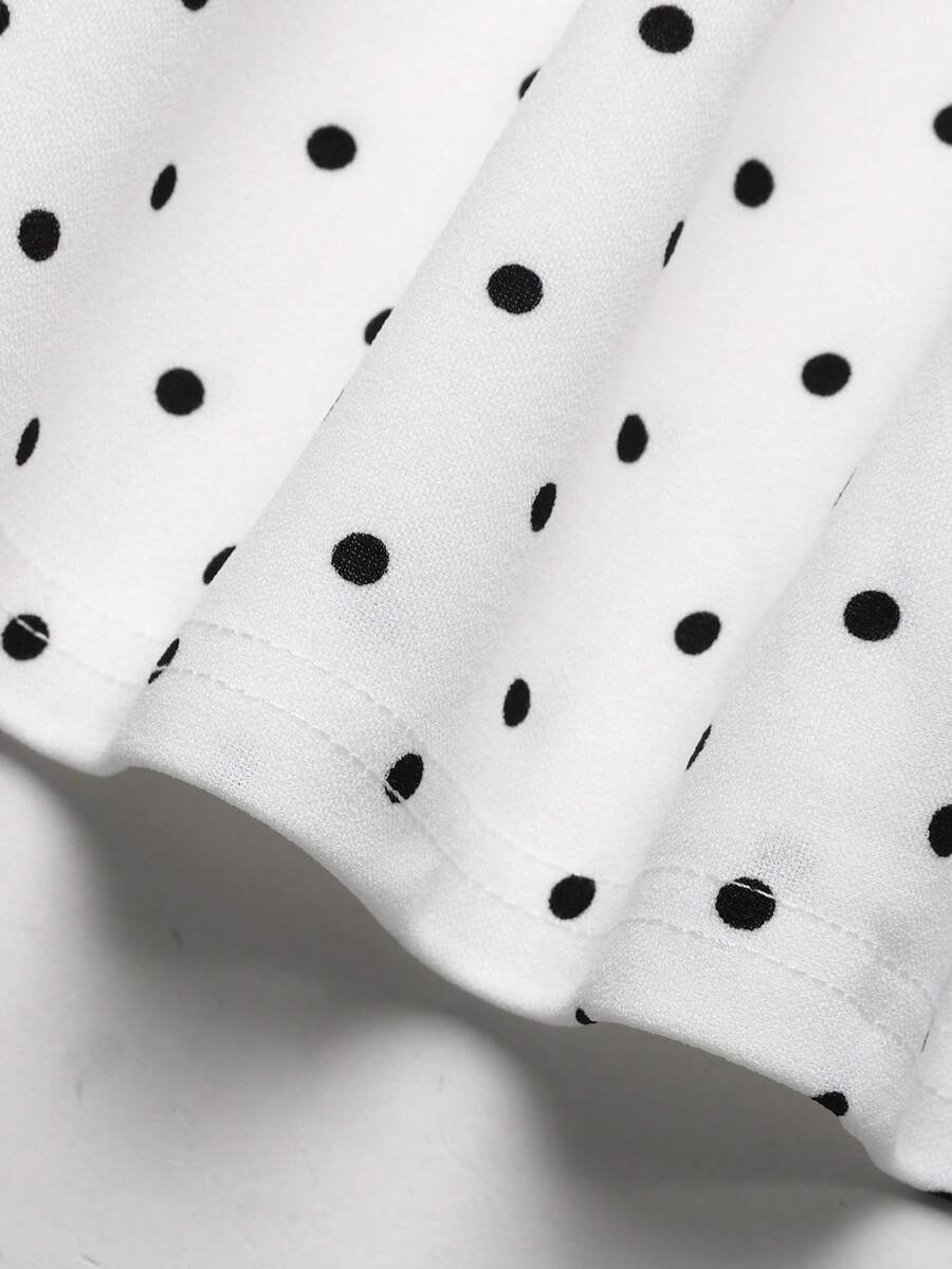 Black and white polka dot sleeveless A-line dress for tween girls featuring a scoop neck, high waist, and flared hem.
