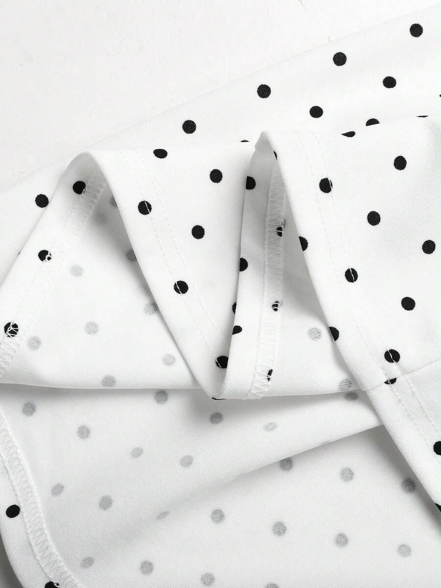 Black and white polka dot sleeveless A-line dress for tween girls featuring a scoop neck, high waist, and flared hem.