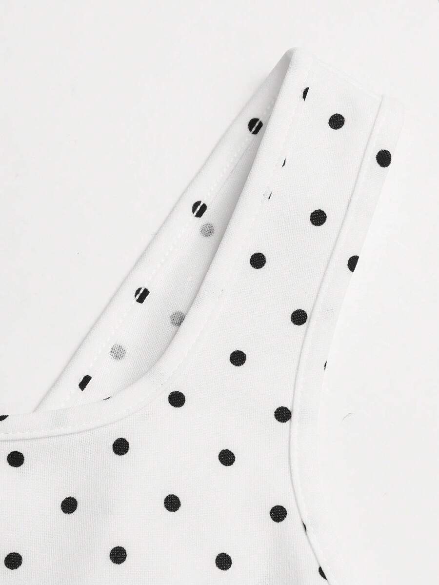 Black and white polka dot sleeveless A-line dress for tween girls featuring a scoop neck, high waist, and flared hem.