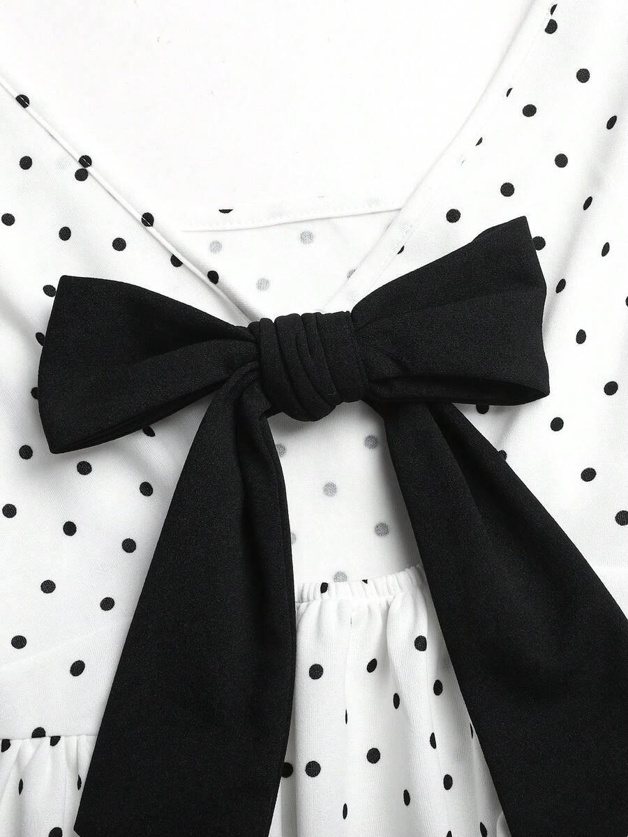 Black and white polka dot sleeveless A-line dress for tween girls featuring a scoop neck, high waist, and flared hem.