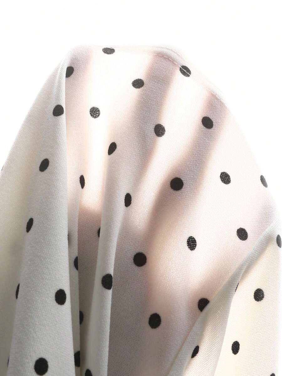 Black and white polka dot sleeveless A-line dress for tween girls featuring a scoop neck, high waist, and flared hem.