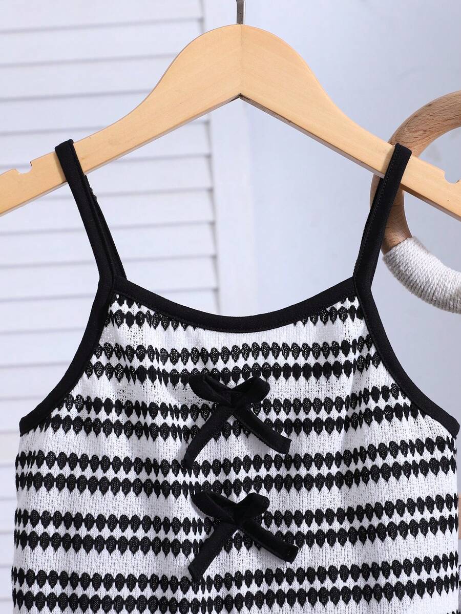 Tween girls black and white striped two-piece set featuring a spaghetti strap micro crop tank top with lettuce trim and ruffle hem paired with matching slim fit shorts.