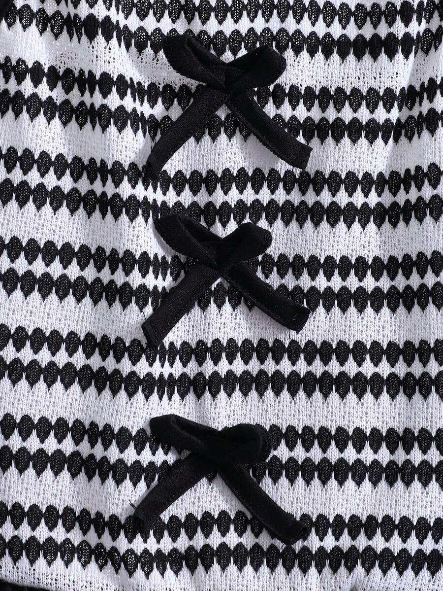 Tween girls black and white striped two-piece set featuring a spaghetti strap micro crop tank top with lettuce trim and ruffle hem paired with matching slim fit shorts.