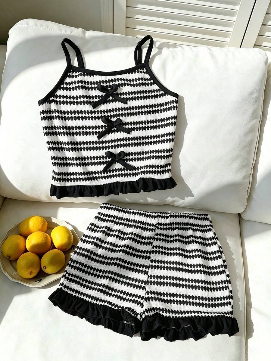 Tween girls black and white striped two-piece set featuring a spaghetti strap micro crop tank top with lettuce trim and ruffle hem paired with matching slim fit shorts.
