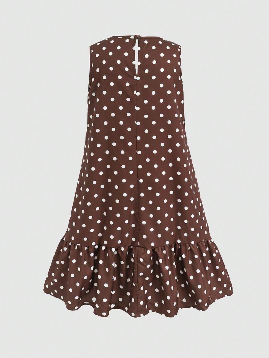 Tween girl wearing a sleeveless black tunic dress featuring a round neck, contrast lace details, and a straight hem.