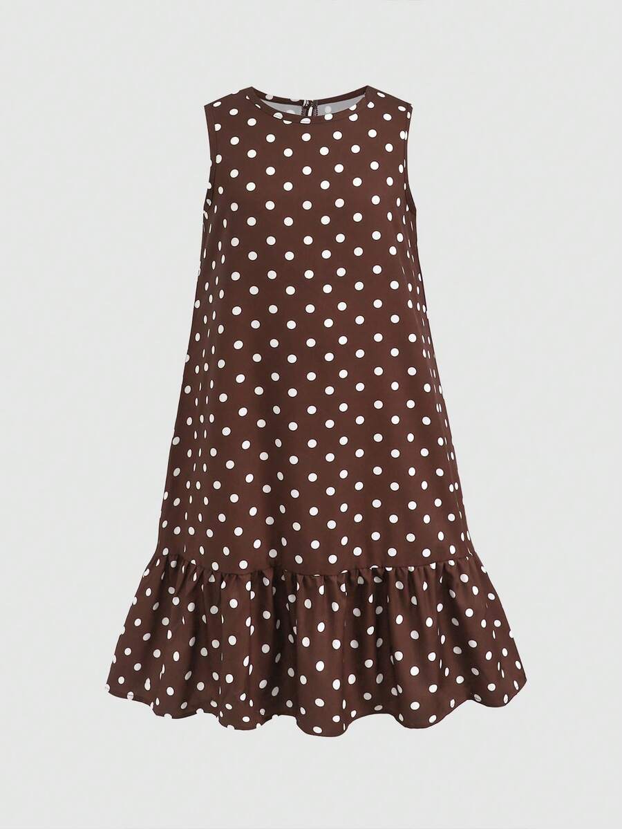 Tween girl wearing a sleeveless black tunic dress featuring a round neck, contrast lace details, and a straight hem.