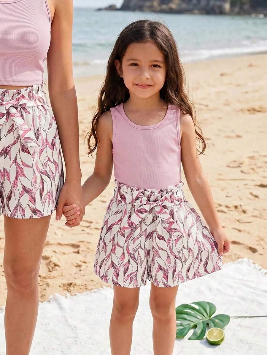 Tween girls 2-piece summer set featuring a turquoise blue ribbed tank top and tropical leaf pattern belted shorts.