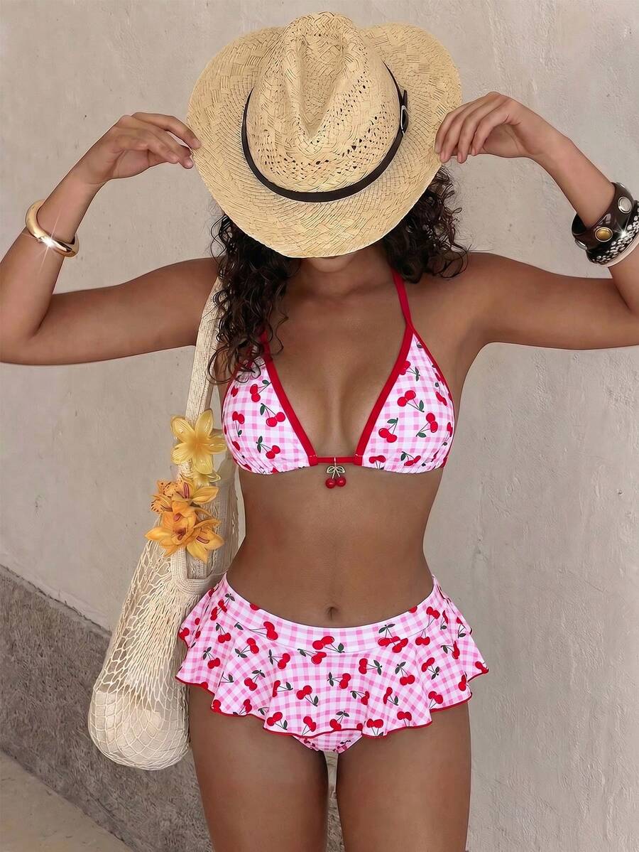 Women's 70s retro black and white polka dot bikini set featuring a halter triangle top and ultra low waist bottoms.