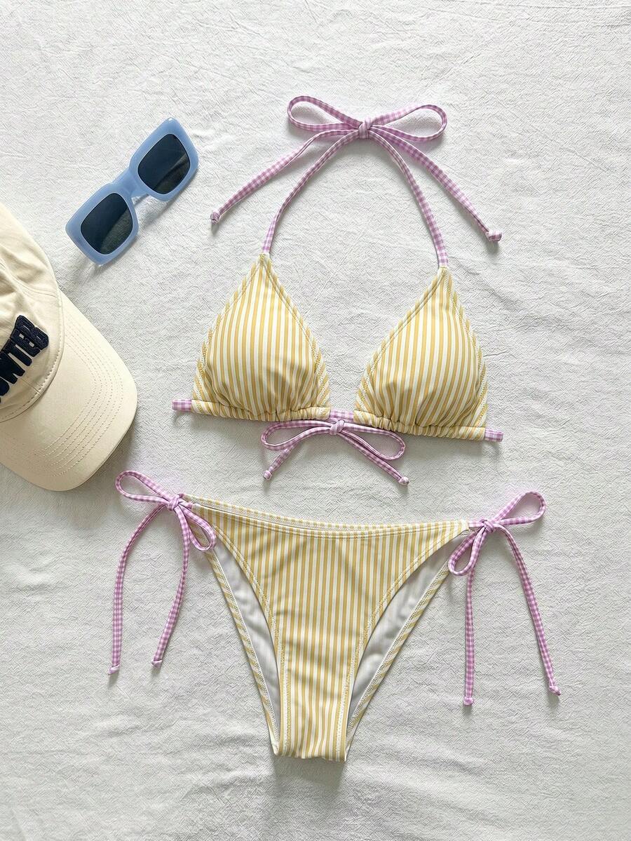 Women's black and white zebra print two-piece bikini set featuring a high waist tie-side bottom and a backless halter top with removable padding.