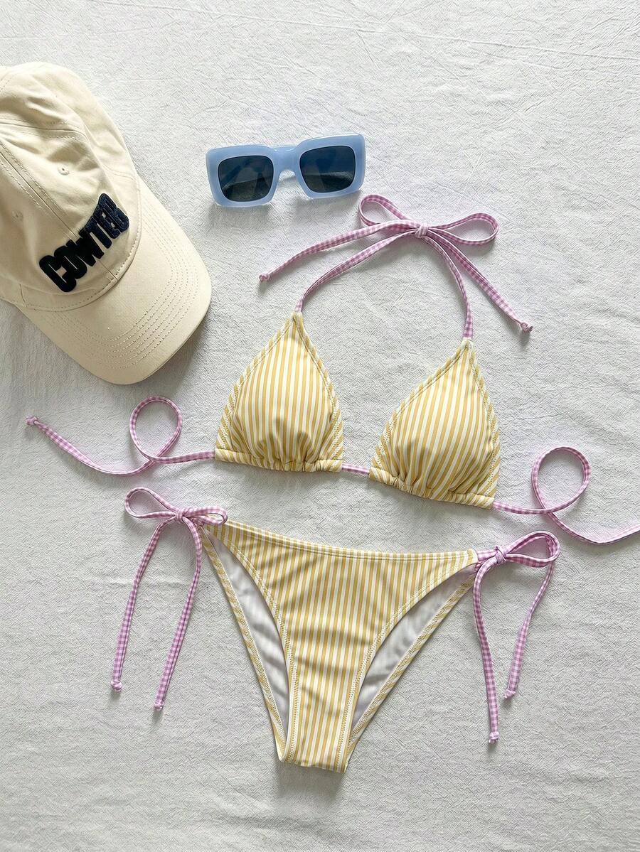Women's black and white zebra print two-piece bikini set featuring a high waist tie-side bottom and a backless halter top with removable padding.