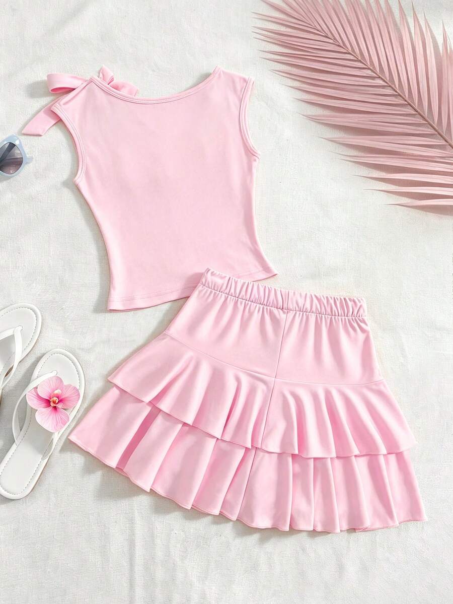 Light blue two-piece outfit set for tween girls with a sleeveless round neck vest top and a tiered ruffle cake skirt featuring a plant pattern.