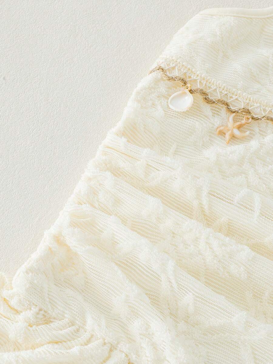 Tween girls apricot sleeveless halter mini dress with textured starfish and shell decor, shirred tiered layer, high waist, and flounce hem.
