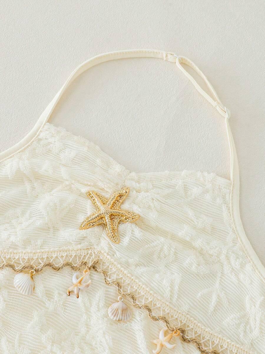 Tween girls apricot sleeveless halter mini dress with textured starfish and shell decor, shirred tiered layer, high waist, and flounce hem.