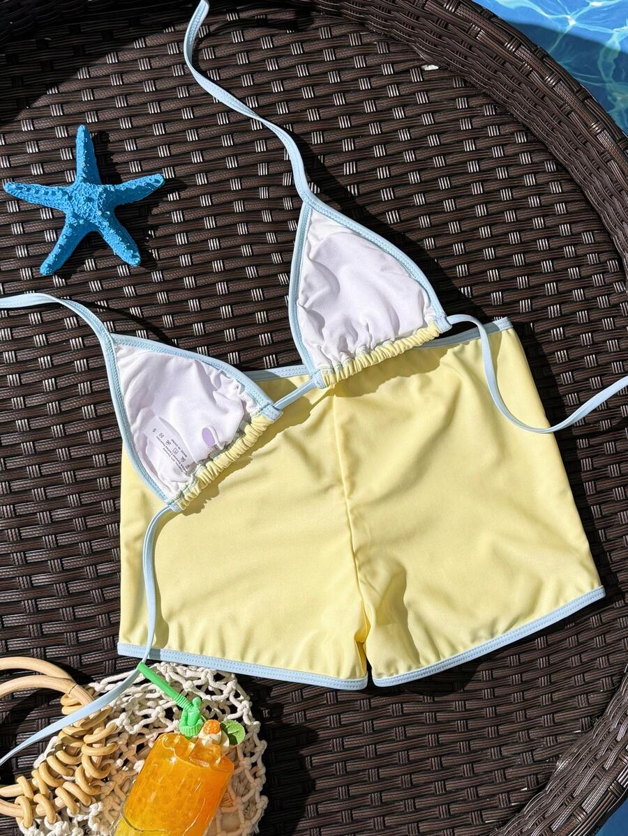 Women's apricot two-piece swimsuit set with a halter tie-back top and matching high stretch shorts.