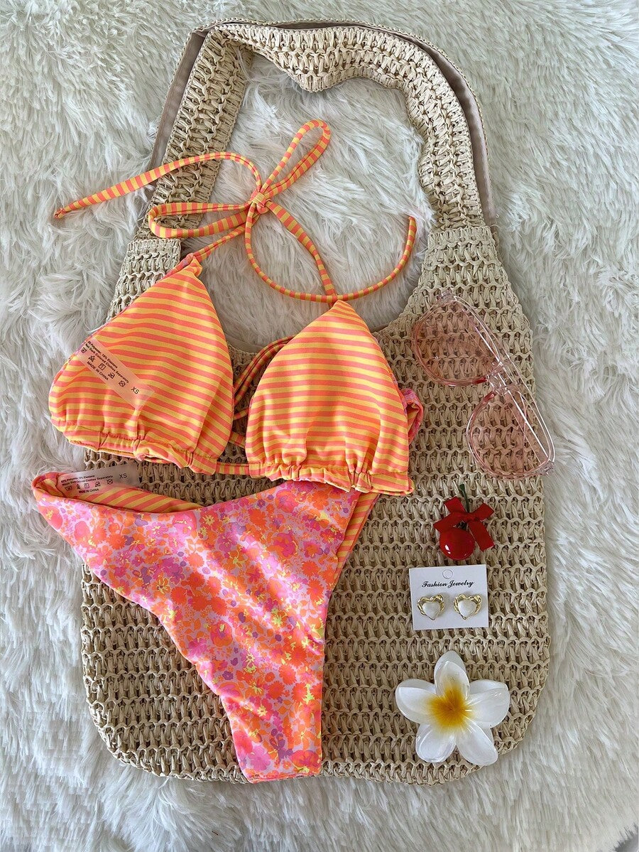 Women's two-piece halter bikini set featuring high cut thong bottoms and removable padding