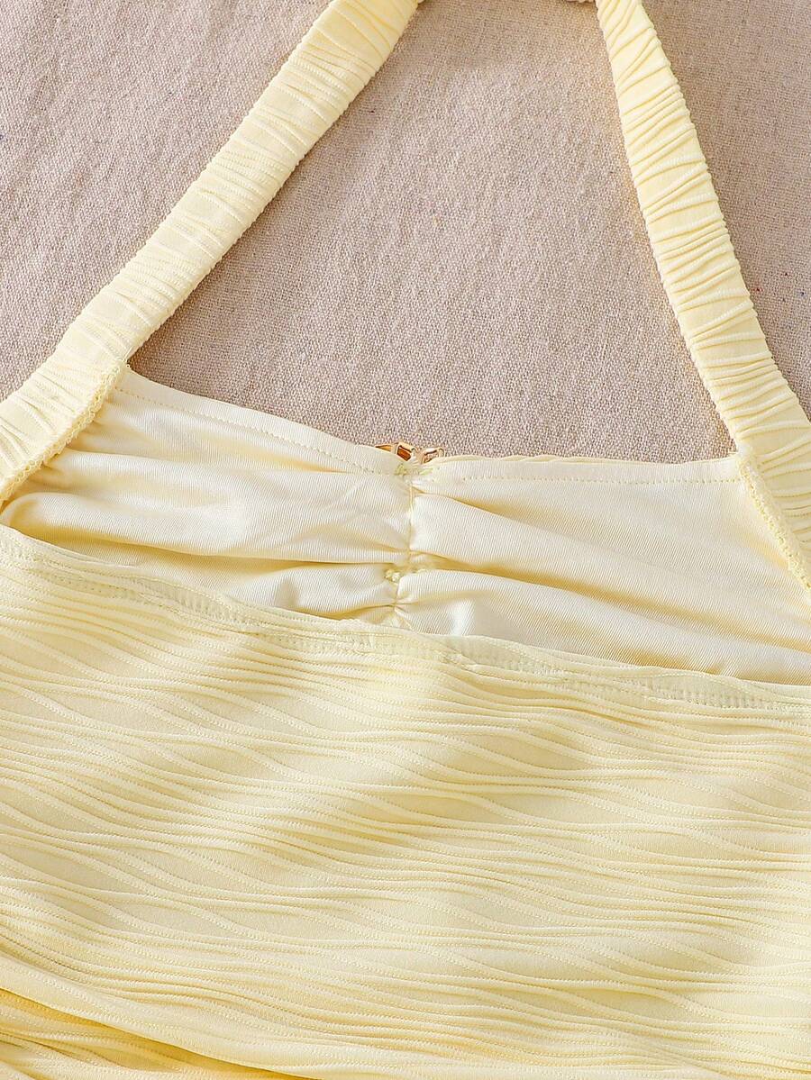 Tween girl yellow mini sundress with large pink floral hibiscus print, spaghetti straps, high waist, flared hem, and sleeveless cami style for summer beach wear