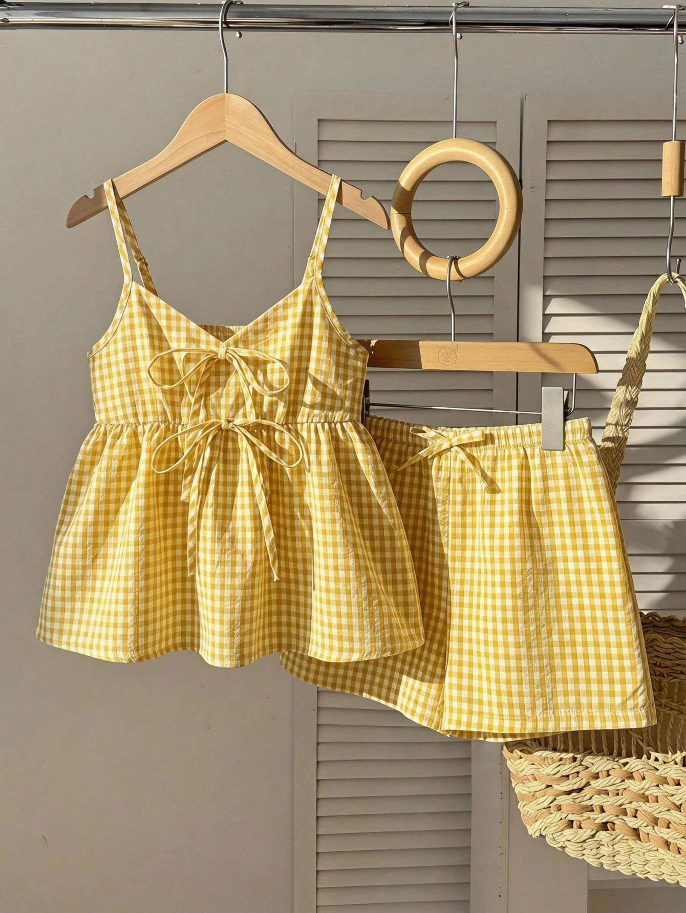 Tween girl 2-piece summer set with a black and white sleeveless striped spaghetti strap tank top with ruffle details and matching casual shorts.