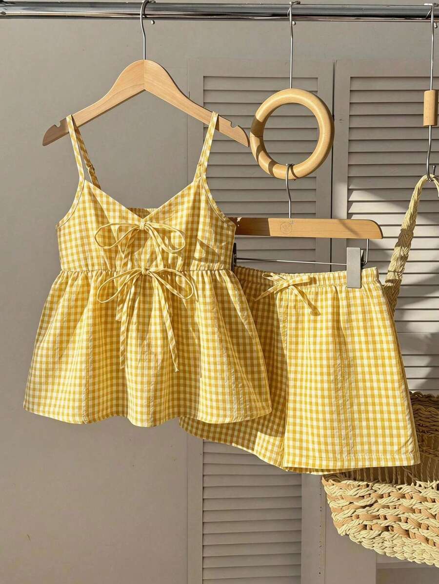 Tween girl 2-piece summer set with a black and white sleeveless striped spaghetti strap tank top with ruffle details and matching casual shorts.