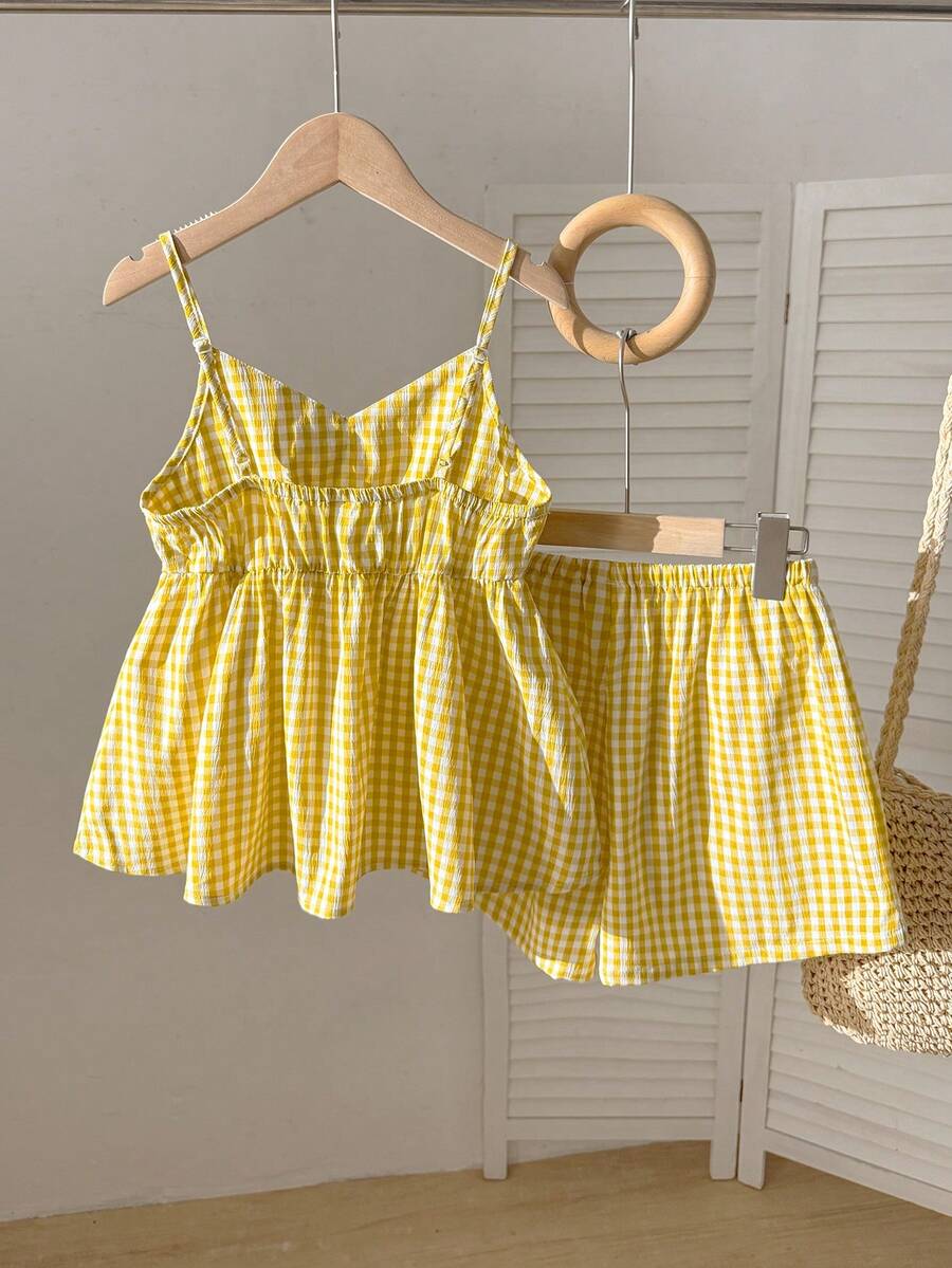 Tween girl 2-piece summer set with a black and white sleeveless striped spaghetti strap tank top with ruffle details and matching casual shorts.