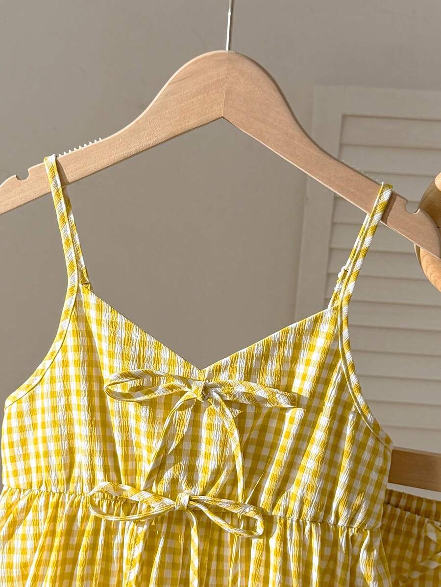 Tween girl 2-piece summer set with a black and white sleeveless striped spaghetti strap tank top with ruffle details and matching casual shorts.